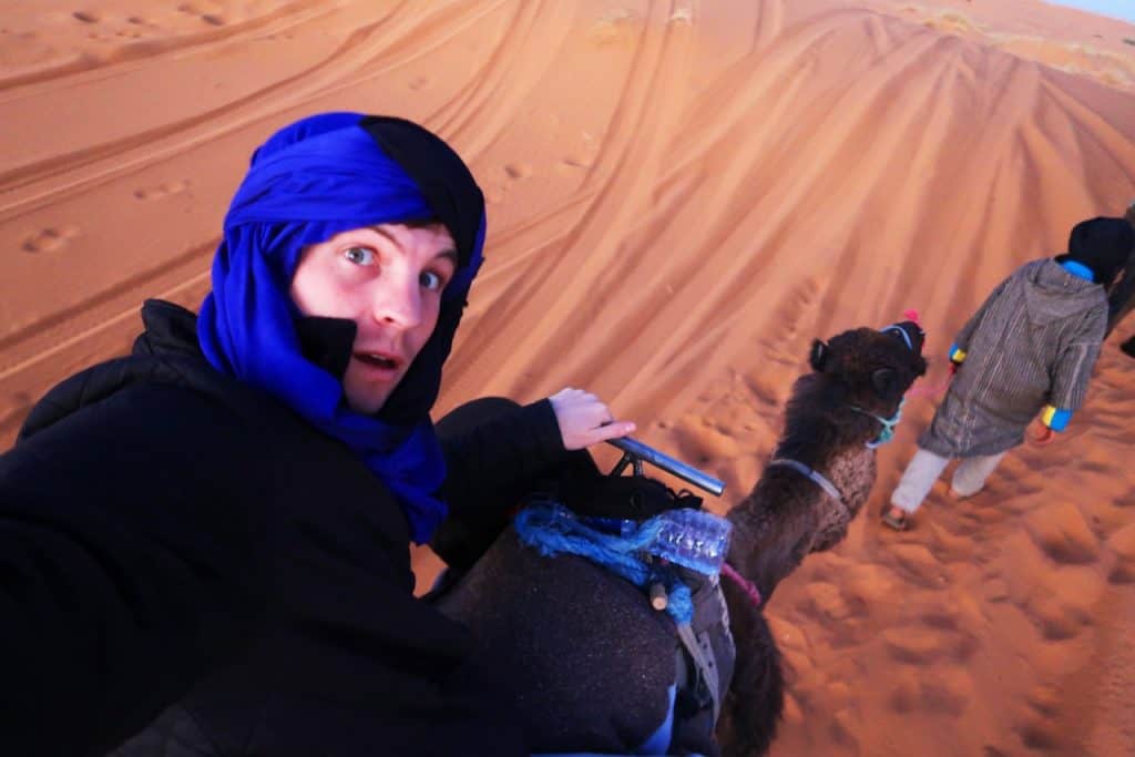 on a camel in sahara desert morocco